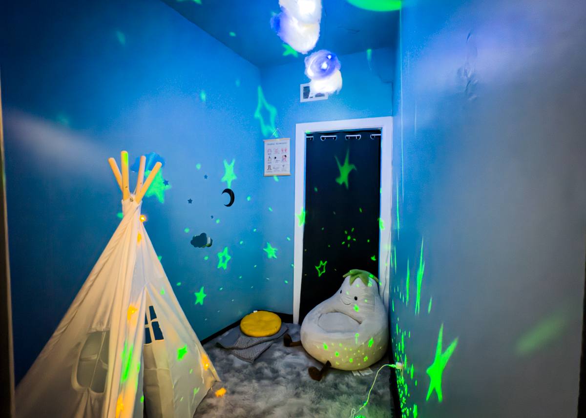 SR Sensory Gym calming room with a sensory tent, soft seating, and projected stars