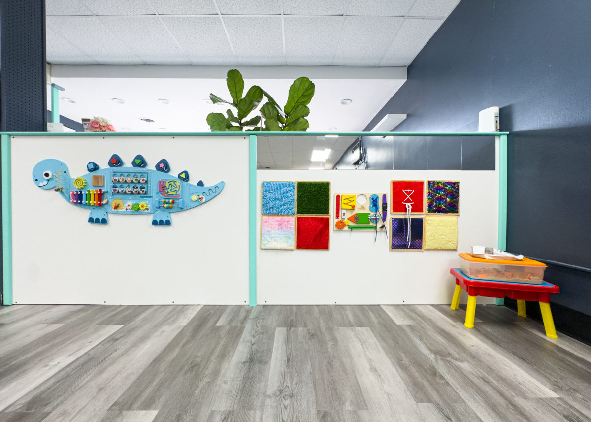 Colorful sensory activity wall inside SR Sensory Gym